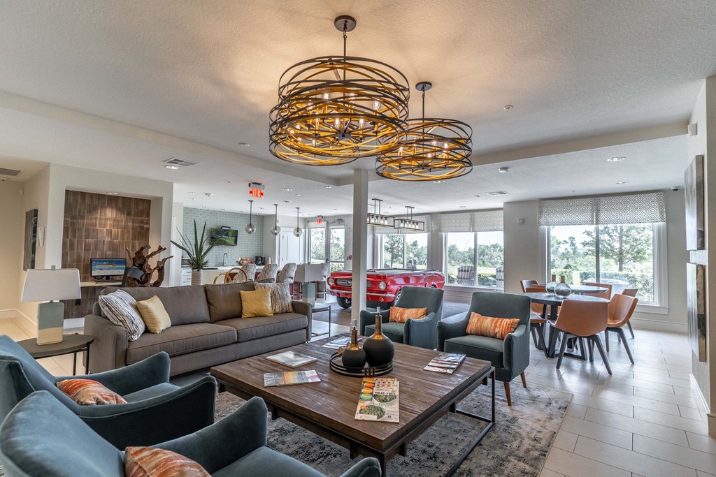 clubhouse with couches and chairs and a table with a vase on it