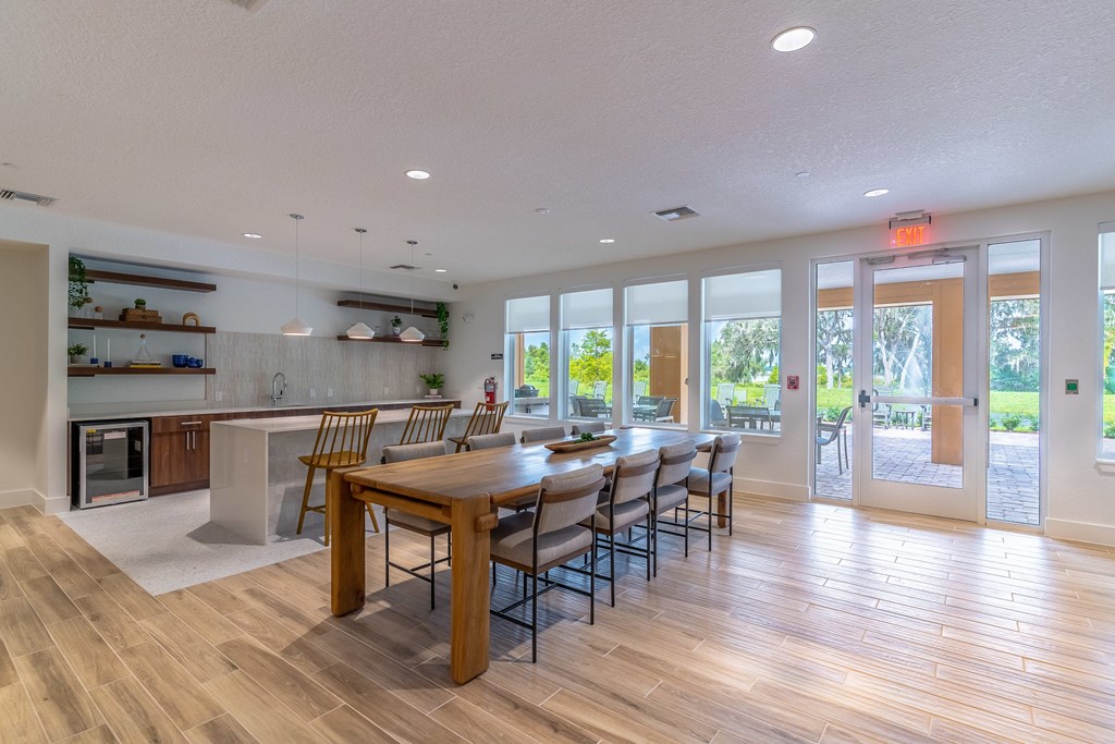 A modern kitchen with a dining table and chairs.