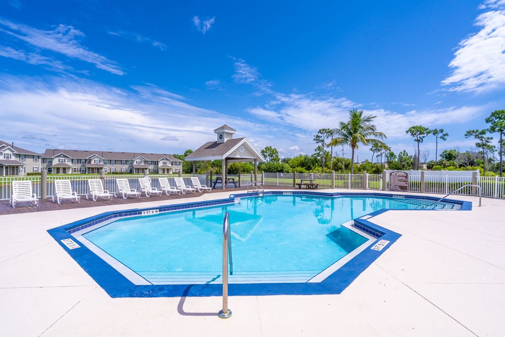 A swimming pool with a blue border and a white pole in the middle.