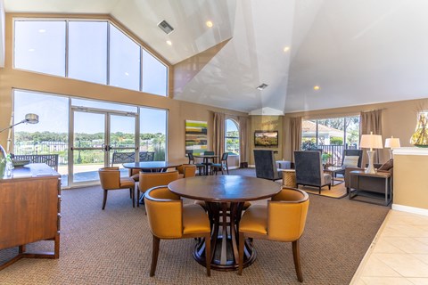 a large living room with a table and chairs