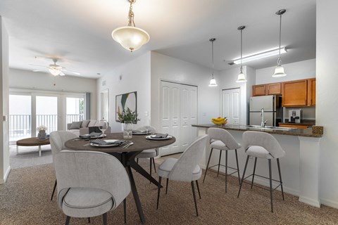 an open kitchen and dining room with a table and chairs