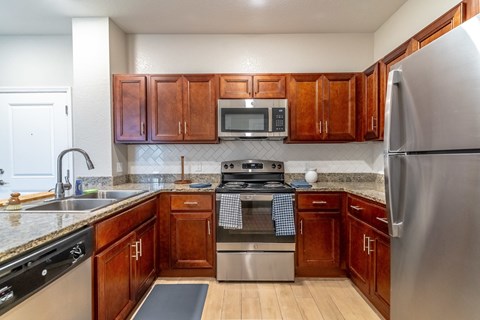 A kitchen with wooden cabinets and stainless steel appliances.