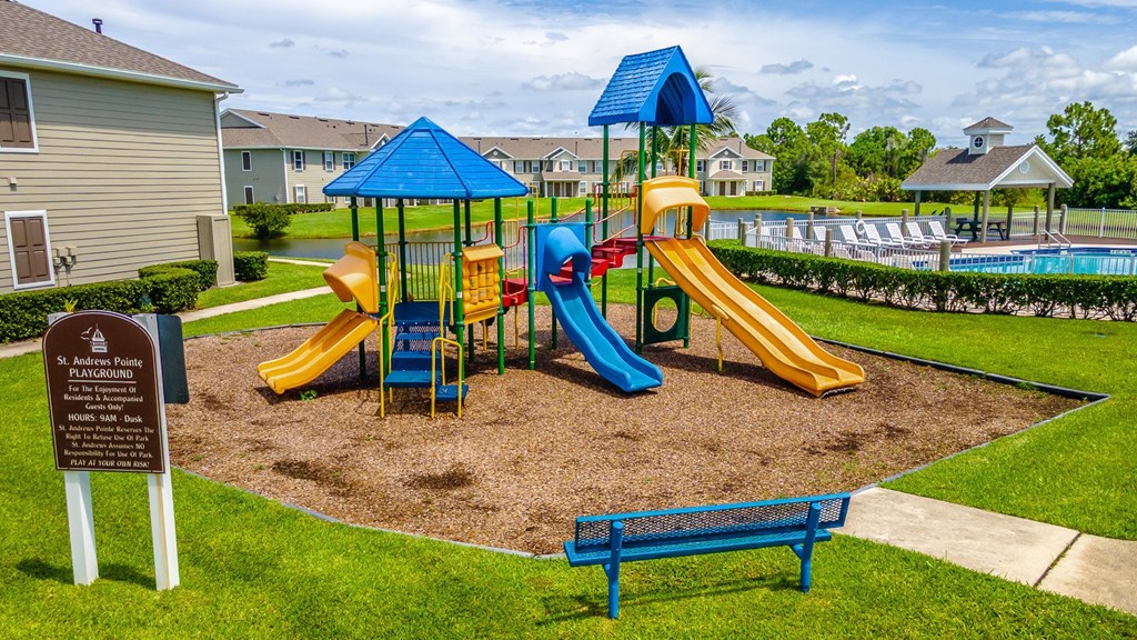 A playground with a blue slide and a yellow slide.
