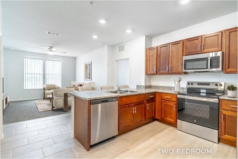 A kitchen with two bedrooms is shown in this image.