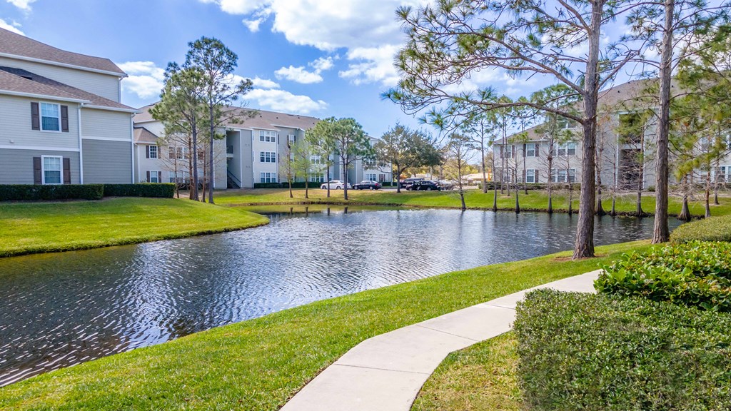 the preserve at ballantyne commons walking path to waterway with apartment buildings
