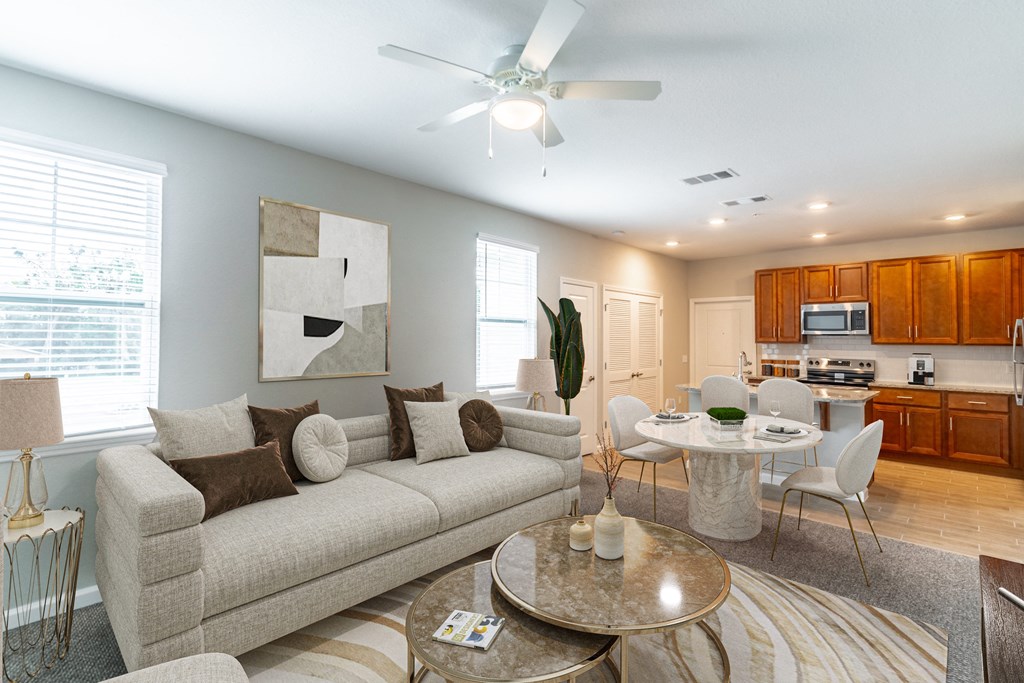 a living room with a couch and a table and a kitchen