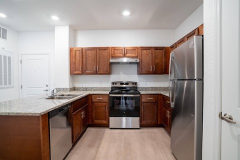 A kitchen with wooden cabinets and stainless steel appliances.