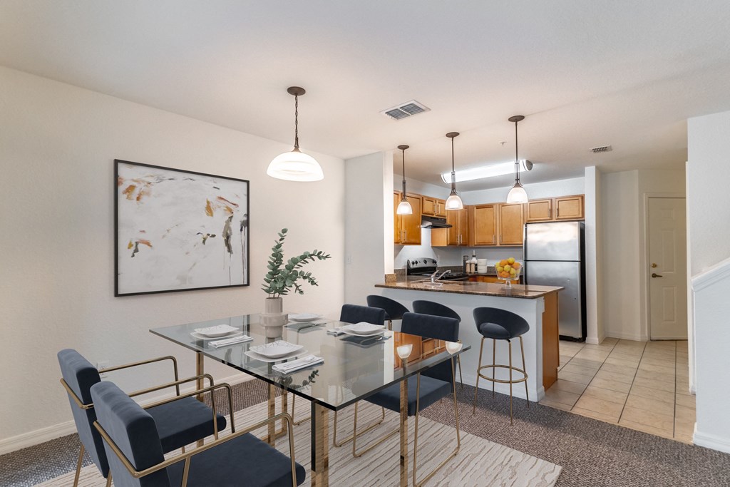 A modern dining area with a glass table and chairs.