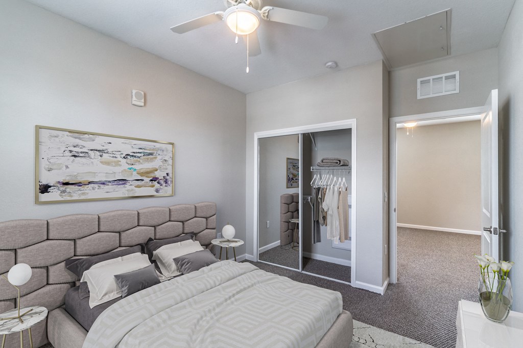 a bedroom with a large bed and a ceiling fan