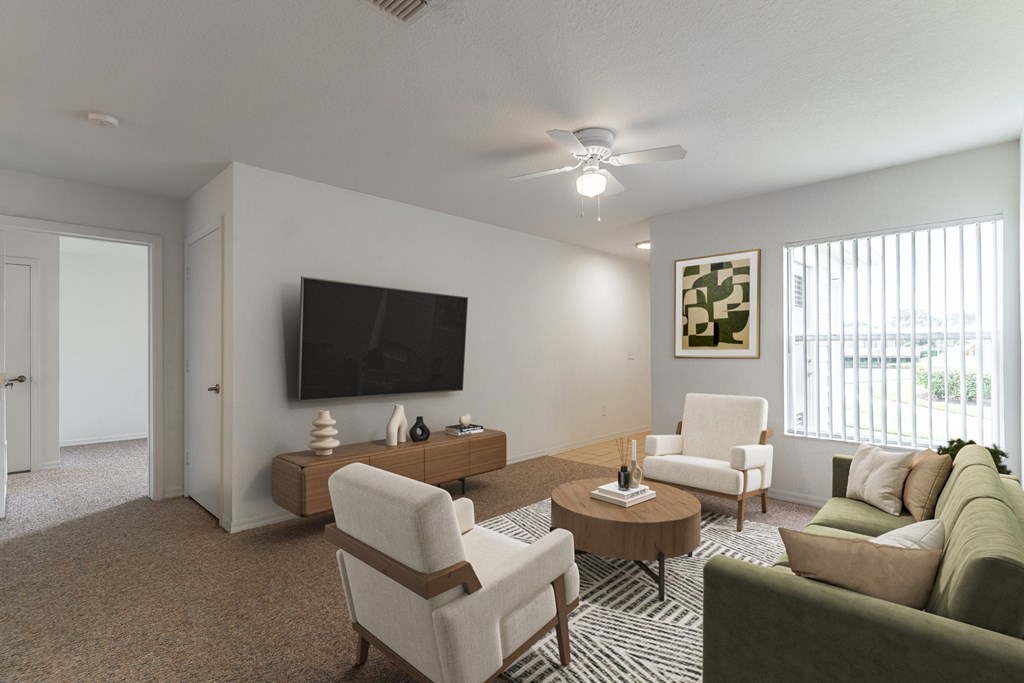 A living room with a flat screen TV, a sofa, a chair, and a coffee table.