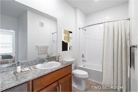 A bathroom with a sink, toilet, and bathtub.