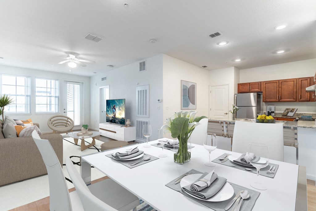 a living room and dining room with a white table and chairs