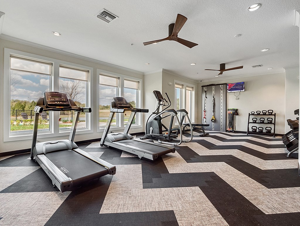 fitness center with equipment and mirror