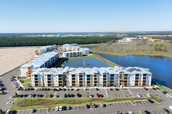 an aerial view of a large apartment complex next to a body of water - Photo Gallery 6