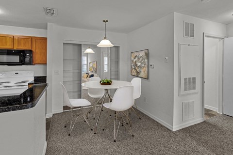a kitchen and dining room with a table and chairs
