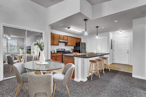 an open kitchen and dining room with a table and chairs
