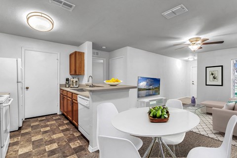 a kitchen and dining area with a white table and chairs