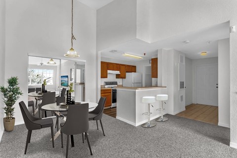 a dining room and kitchen with a table and chairs