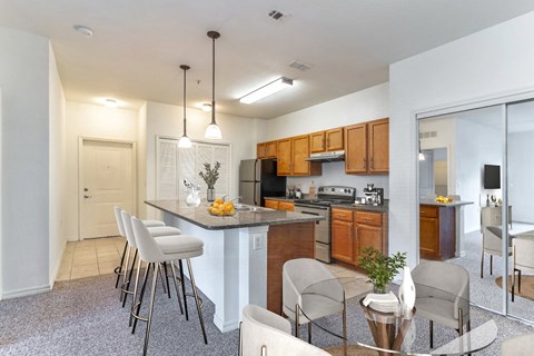 an open kitchen and dining area with a table and chairs
