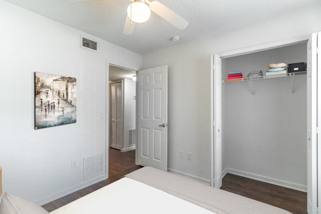 a bedroom with a bed and a ceiling fan