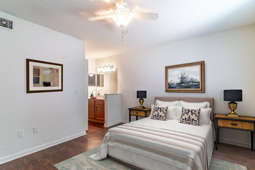 a bedroom with a bed and a ceiling fan