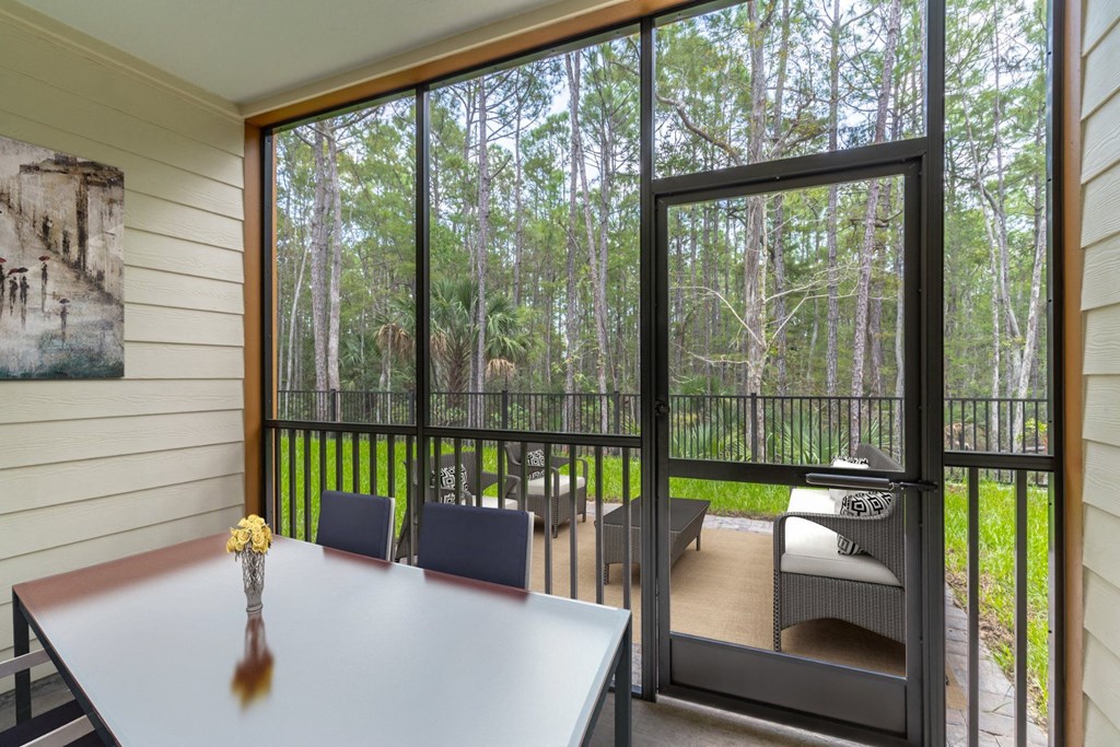 a room with a table and chairs and a sliding glass door