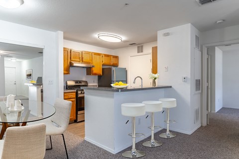 a kitchen and dining area with a glass table and chairs