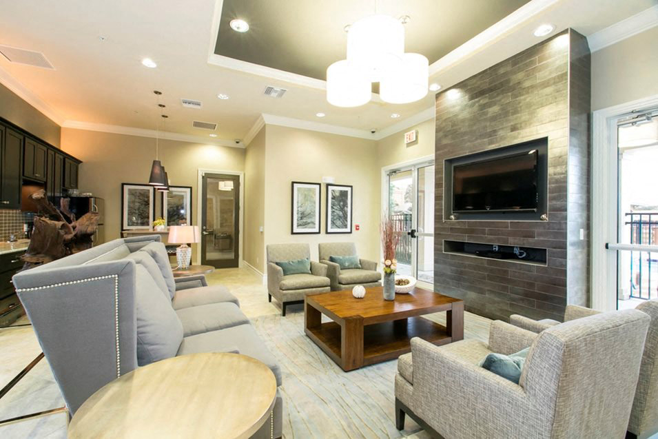 a living room with couches a table and a television