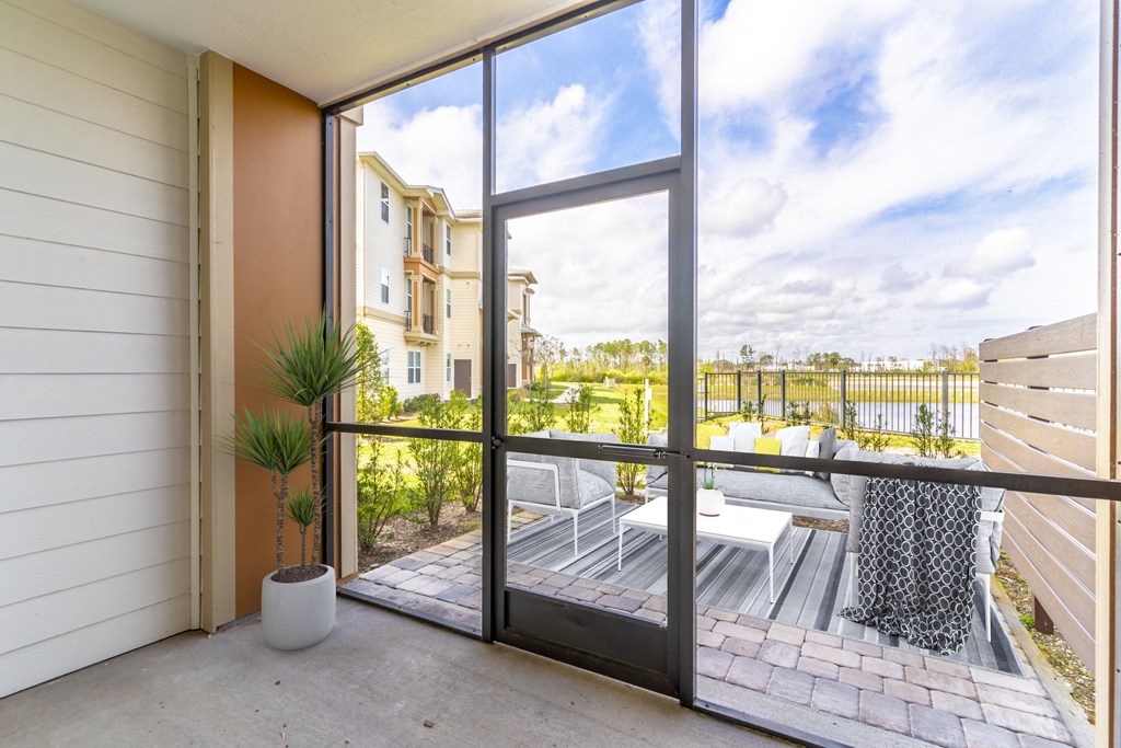 a balcony with a patio and a large glass door