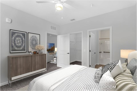 A bedroom with a bed, dresser, and mirror.