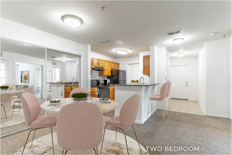 A modern kitchen with a dining table and chairs.