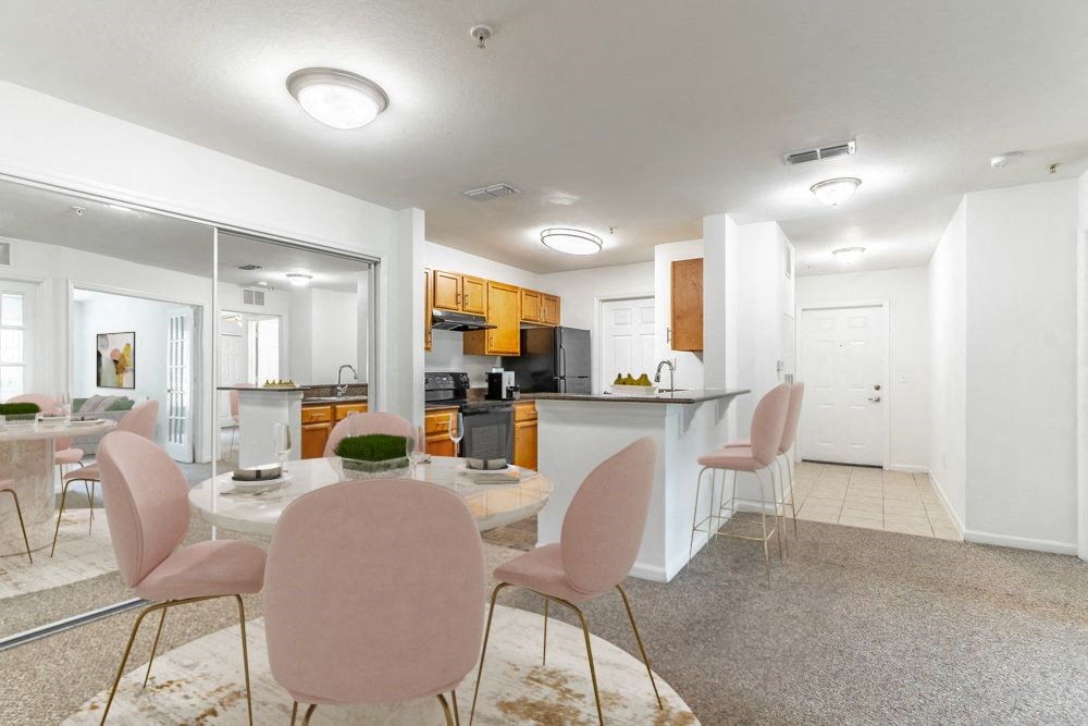 a dining room and kitchen with a table and chairs
