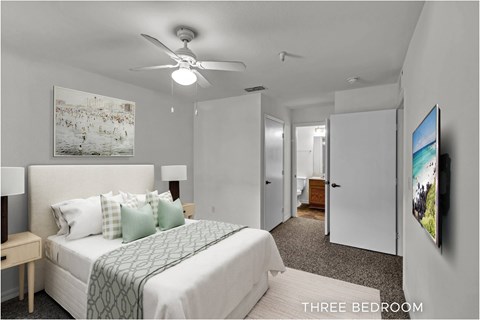 A bedroom with a bed, a ceiling fan, and a painting on the wall.