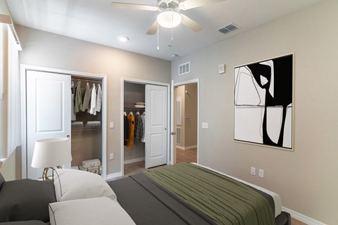 a bedroom with a bed and a ceiling fan