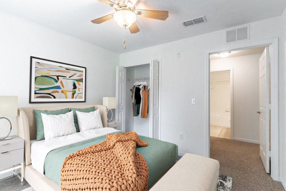 a bedroom with a bed and a ceiling fan