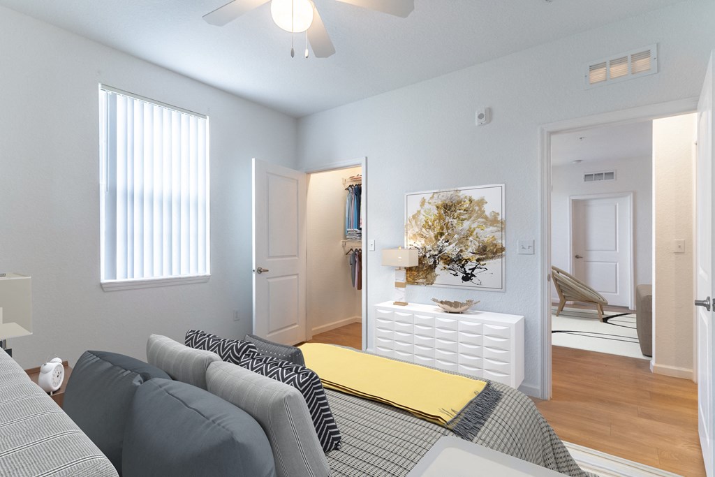 a bedroom with a bed and a white dresser with a yellow blanket