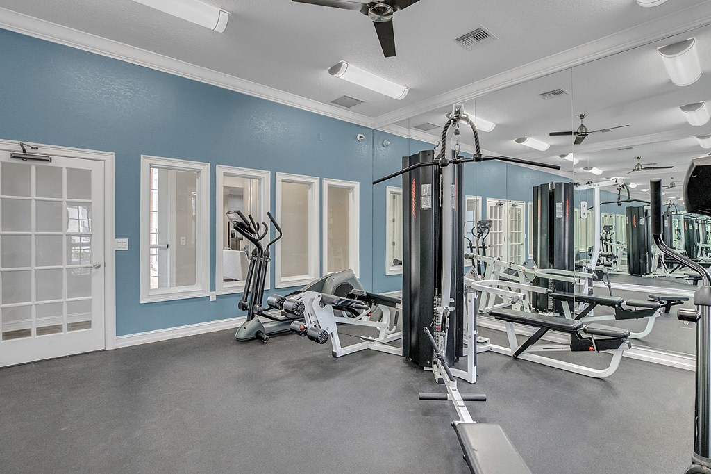 fitness center with equipment and mirror