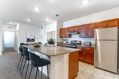 a kitchen with a granite counter top and stainless steel appliances