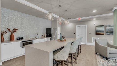 a kitchen and dining room with white cabinets and a white counter top