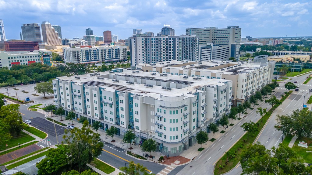 an aerial view of an apartment complex with a cityscape in the background