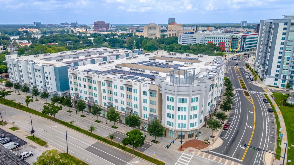 an aerial view of a large white building with many windows