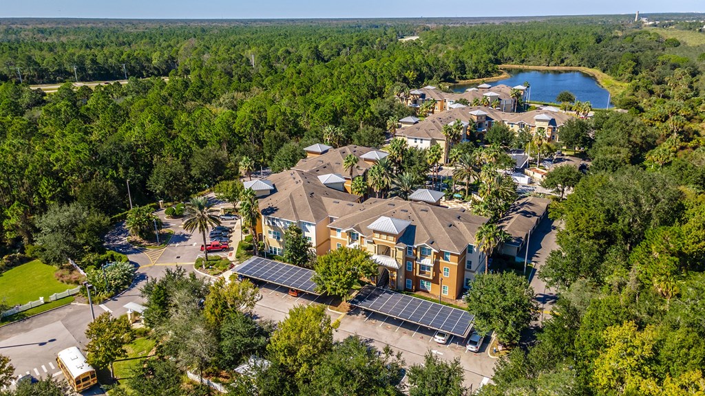an aerial view of a community with solar panels on the roofs