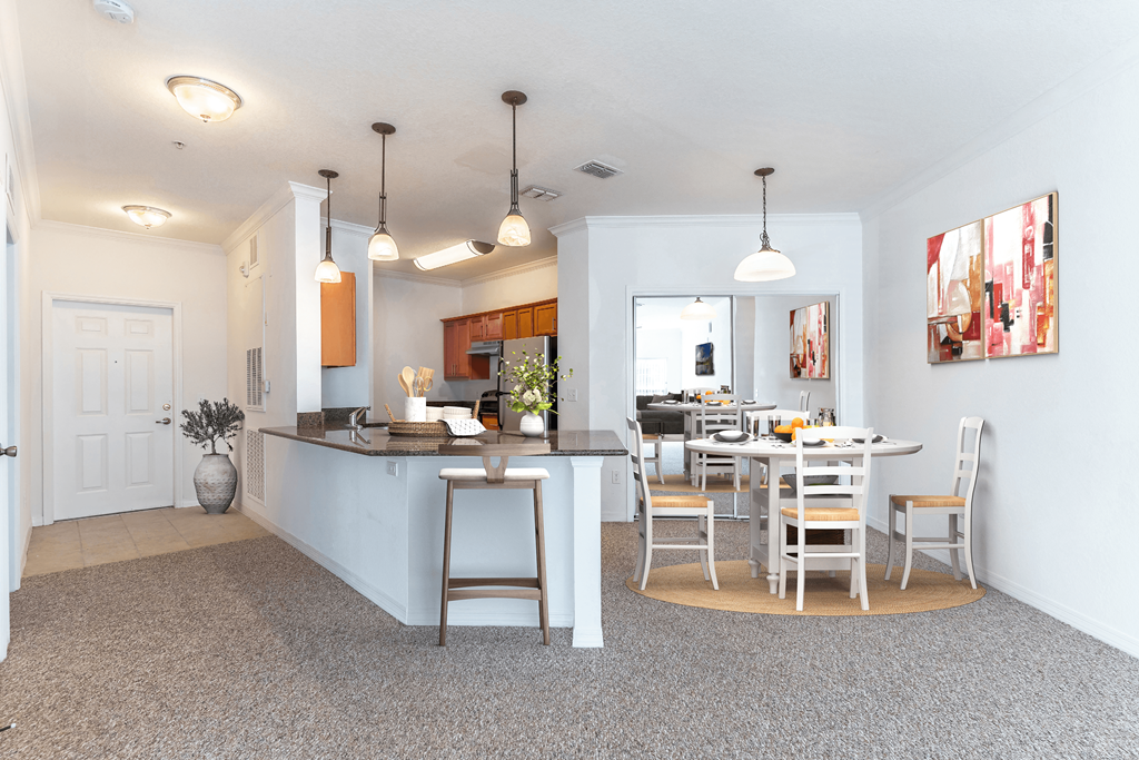 a kitchen and dining room with a table and chairs