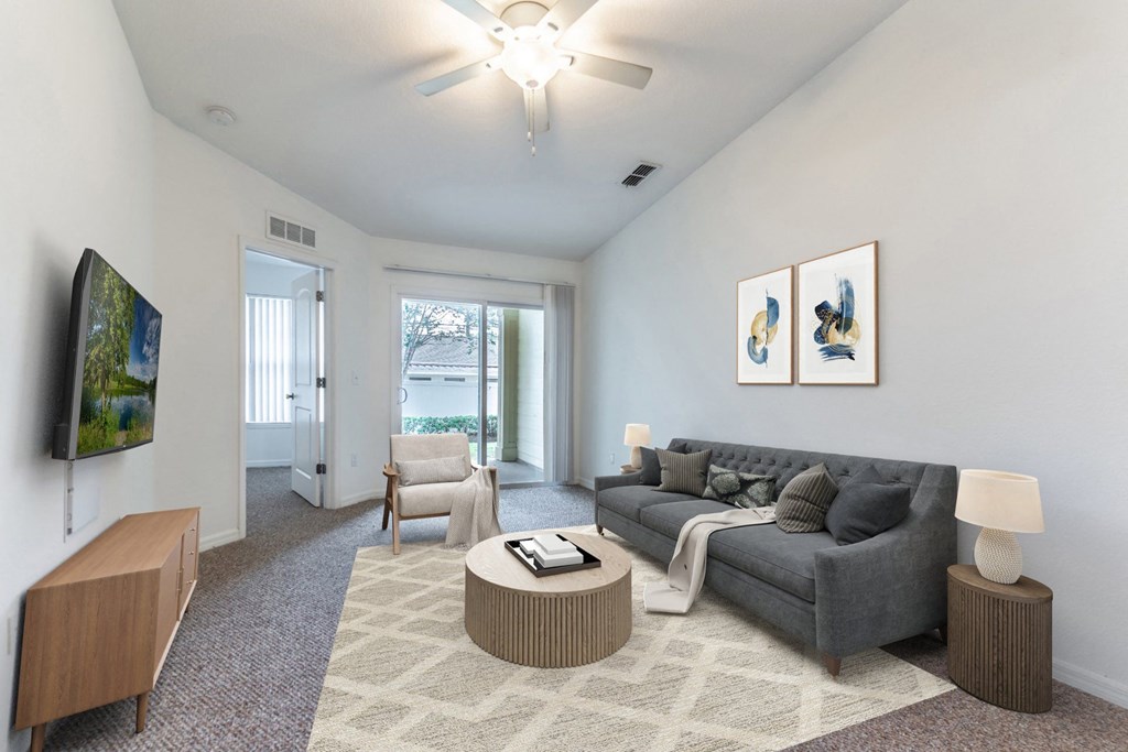a living room with white walls and a gray couch