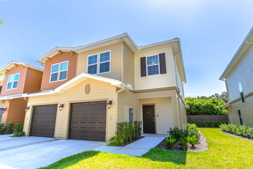 a house with two garages and a lawn