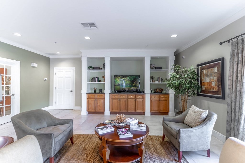 a living room filled with furniture and a flat screen tv