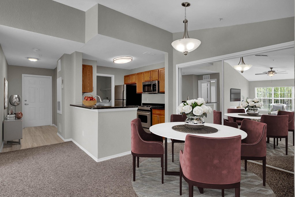 A modern kitchen with a dining table set for four.