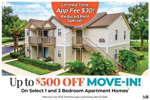 A large two-story apartment building with a red and white advertisement offering a limited-time app fee discount and a move-in special.