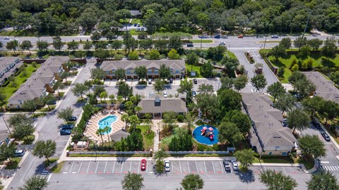 an aerial view of a community with several houses and a swimming pool