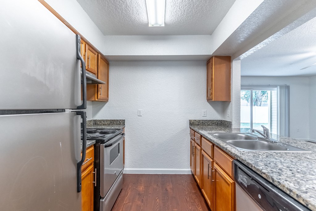 a kitchen with granite countertops and stainless steel appliances
